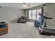Spacious living room featuring neutral carpet, large window, and ceiling fan at 5008 Casland Dr, Raleigh, NC 27604
