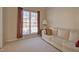 Cozy living room with plush carpet, natural light, and a comfortable sofa at 5008 Casland Dr, Raleigh, NC 27604