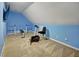 Workout area featuring blue walls, carpet, exercise bike, and weight rack at 5008 Casland Dr, Raleigh, NC 27604