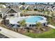 Aerial view of the community pool with black lounge furniture and gray shelter in neighborhood at 504 Lemon Daisy Ln, Knightdale, NC 27545