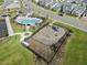 Overhead view of a playground and pool area in a new neighborhood development, framed by homes at 504 Lemon Daisy Ln, Knightdale, NC 27545