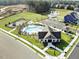 Enjoy this aerial view of the community pool, playground, and amenity center with pond and construction nearby at 504 Lemon Daisy Ln, Knightdale, NC 27545