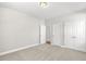 Neutral bedroom with carpet, closet doors, and ample space at 504 Lemon Daisy Ln, Knightdale, NC 27545