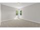 Bright bedroom featuring plush carpeting and natural light from dual windows at 504 Lemon Daisy Ln, Knightdale, NC 27545