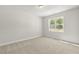 Neutral bedroom with plush carpeting and a bright window view at 504 Lemon Daisy Ln, Knightdale, NC 27545
