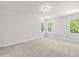 Bedroom with neutral walls, carpet flooring, and two large windows providing natural light at 504 Lemon Daisy Ln, Knightdale, NC 27545