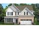 Charming new two-story home with white siding, brick accents, and attached two car garage at 504 Lemon Daisy Ln, Knightdale, NC 27545