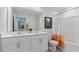 Bathroom with double sink vanity, a toilet, and tub with orange striped curtain at 515 Old Battle Bridge Rd, Wendell, NC 27591