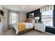 Bedroom displays a plush bed, stylish nightstand, and bright windows at 515 Old Battle Bridge Rd, Wendell, NC 27591