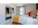 Bedroom showcases a cozy bed, bright window, and a large mirror at 515 Old Battle Bridge Rd, Wendell, NC 27591