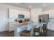 Bright kitchen featuring white cabinets, stainless steel appliances, and a granite countertop island at 515 Old Battle Bridge Rd, Wendell, NC 27591