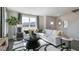 Open-concept living room with large window and cozy white sofa, perfect for relaxation at 515 Old Battle Bridge Rd, Wendell, NC 27591