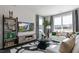 Bright living room with large windows and decorative shelving featuring comfy white sofa at 515 Old Battle Bridge Rd, Wendell, NC 27591