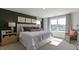 Cozy main bedroom featuring a large window, side tables with lamps, and neutral decor at 515 Old Battle Bridge Rd, Wendell, NC 27591