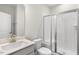 Bright bathroom featuring a frameless glass shower door and quartz countertops at 528 Lemon Daisy Ln, Knightdale, NC 27545