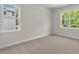Comfortable bedroom with plush carpeting and two large windows providing great natural light at 528 Lemon Daisy Ln, Knightdale, NC 27545
