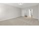 Inviting carpeted bedroom with ample closet space and doorway, offering comfort and functionality at 528 Lemon Daisy Ln, Knightdale, NC 27545