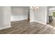 Dining room with wainscoting, wood floors, and a view to the kitchen at 528 Lemon Daisy Ln, Knightdale, NC 27545