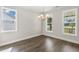 Elegant dining room featuring stylish chandelier, ample windows, and wood-look floors at 528 Lemon Daisy Ln, Knightdale, NC 27545
