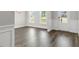 Sun-drenched entryway with hardwood floors, white wainscoting, and a view to the outside at 528 Lemon Daisy Ln, Knightdale, NC 27545