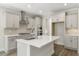 New kitchen with white cabinets, an island, and stainless steel appliances at 528 Lemon Daisy Ln, Knightdale, NC 27545