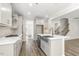 Modern kitchen featuring white cabinets, stainless steel appliances, and a large island with a sink at 528 Lemon Daisy Ln, Knightdale, NC 27545