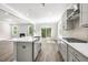 Bright, open-concept kitchen with stainless steel appliances, a center island and access to the fireplace and deck at 528 Lemon Daisy Ln, Knightdale, NC 27545