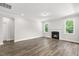 Bright living room with hardwood floors, a fireplace, and plenty of natural light at 528 Lemon Daisy Ln, Knightdale, NC 27545