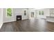 Open-concept living area with modern flooring, fireplace, and access to outdoor deck at 528 Lemon Daisy Ln, Knightdale, NC 27545