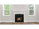 Bright living room with a cozy fireplace and abundant natural light from large windows at 528 Lemon Daisy Ln, Knightdale, NC 27545