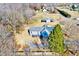 Aerial view of charming home with a mature tree and spacious grounds in a quiet residential area at 57 Lowell Ct, Smithfield, NC 27577