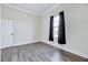 Bedroom with hardwood floors, large window, and neutral colored walls at 57 Lowell Ct, Smithfield, NC 27577