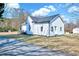 The exterior features white siding, dark trim, mature trees, and a well-manicured lawn at 57 Lowell Ct, Smithfield, NC 27577