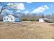 The exterior features white siding, mature trees, and a storage shed, exuding Southern charm at 57 Lowell Ct, Smithfield, NC 27577