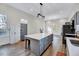 Open kitchen layout with an island, sleek countertops and a modern lighting fixture at 57 Lowell Ct, Smithfield, NC 27577