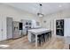 Bright kitchen features a large island with seating, stainless steel appliances, and modern light fixtures at 57 Lowell Ct, Smithfield, NC 27577