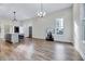 Open concept living room boasts hardwood floors, large windows, and contemporary lighting at 57 Lowell Ct, Smithfield, NC 27577