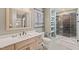 Well-lit bathroom featuring a modern vanity, a glass shower with a shower bench and a decorative wall poster at 614 Capital Blvd # 229, Raleigh, NC 27603