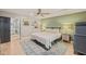 Cozy bedroom with a ceiling fan, light green accent wall, bedside lamps, and view to the ensuite bathroom at 614 Capital Blvd # 229, Raleigh, NC 27603