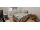 Cozy bedroom featuring a colorful quilt on a single bed, paired with a retro wooden nightstand at 614 Capital Blvd # 229, Raleigh, NC 27603