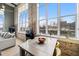 Bright dining area with exposed brick, large windows, and modern furniture arrangements at 614 Capital Blvd # 229, Raleigh, NC 27603