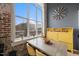 Bright dining area with brick accent wall, modern furniture, and a large window with a view at 614 Capital Blvd # 229, Raleigh, NC 27603
