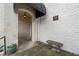 Historic brick building entrance featuring a covered archway, stone bench, and lush plants offering a quaint welcome at 614 Capital Blvd # 229, Raleigh, NC 27603