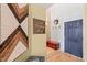 Cozy entryway with a wooden chest, decorative wall art, light hardwood flooring, and a blue front door at 614 Capital Blvd # 229, Raleigh, NC 27603