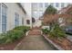 Charming brick building with manicured landscaping and steps leading to a covered entrance, evoking classic appeal at 614 Capital Blvd # 229, Raleigh, NC 27603