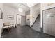 Hallway with grey-painted walls, tiled floors, neutral chair, staircase, and art creating a modern aesthetic at 614 Capital Blvd # 229, Raleigh, NC 27603