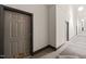 Hallway featuring neutral walls, patterned carpets, and doors with unit number 229 at 614 Capital Blvd # 229, Raleigh, NC 27603