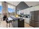 Modern kitchen with white cabinets, stainless steel appliances, breakfast bar, and natural light at 614 Capital Blvd # 229, Raleigh, NC 27603