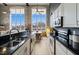 Modern kitchen with stainless appliances and granite counters, open to dining area with large windows at 614 Capital Blvd # 229, Raleigh, NC 27603
