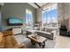 Bright living room with exposed brick, oversized windows, and comfortable seating with rustic coffee table at 614 Capital Blvd # 229, Raleigh, NC 27603